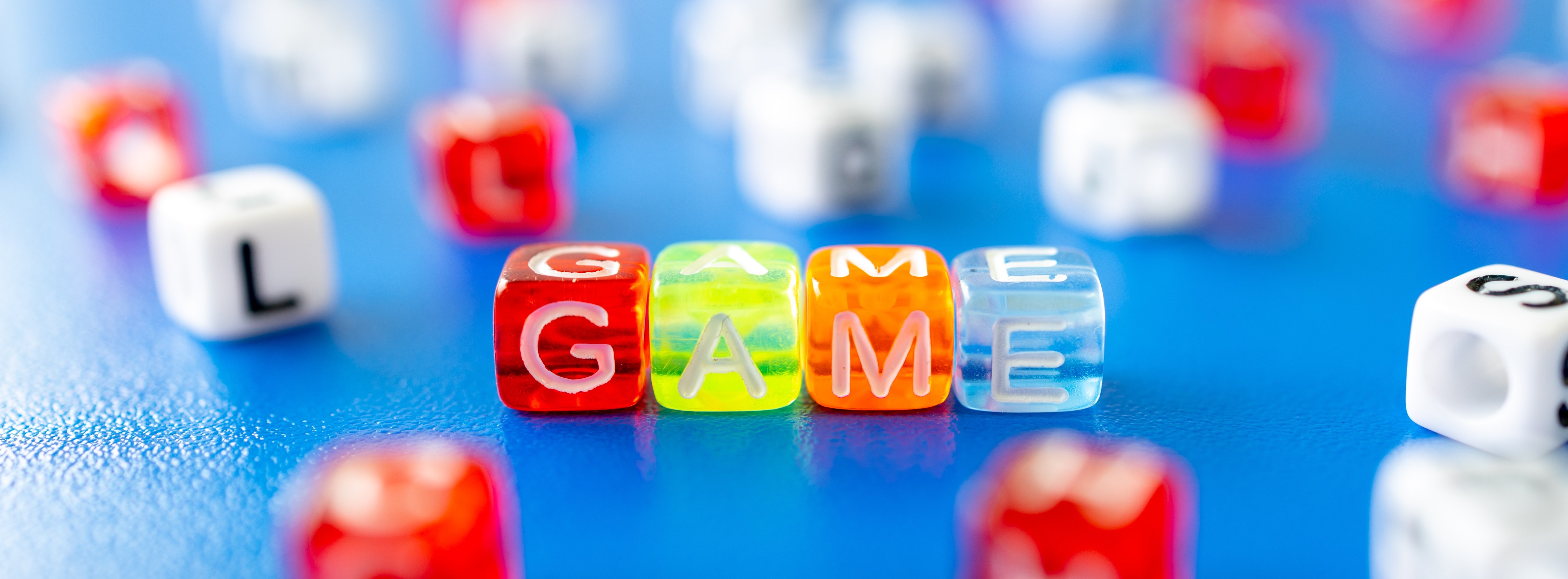 Letter Dice spelling out the word 'game'